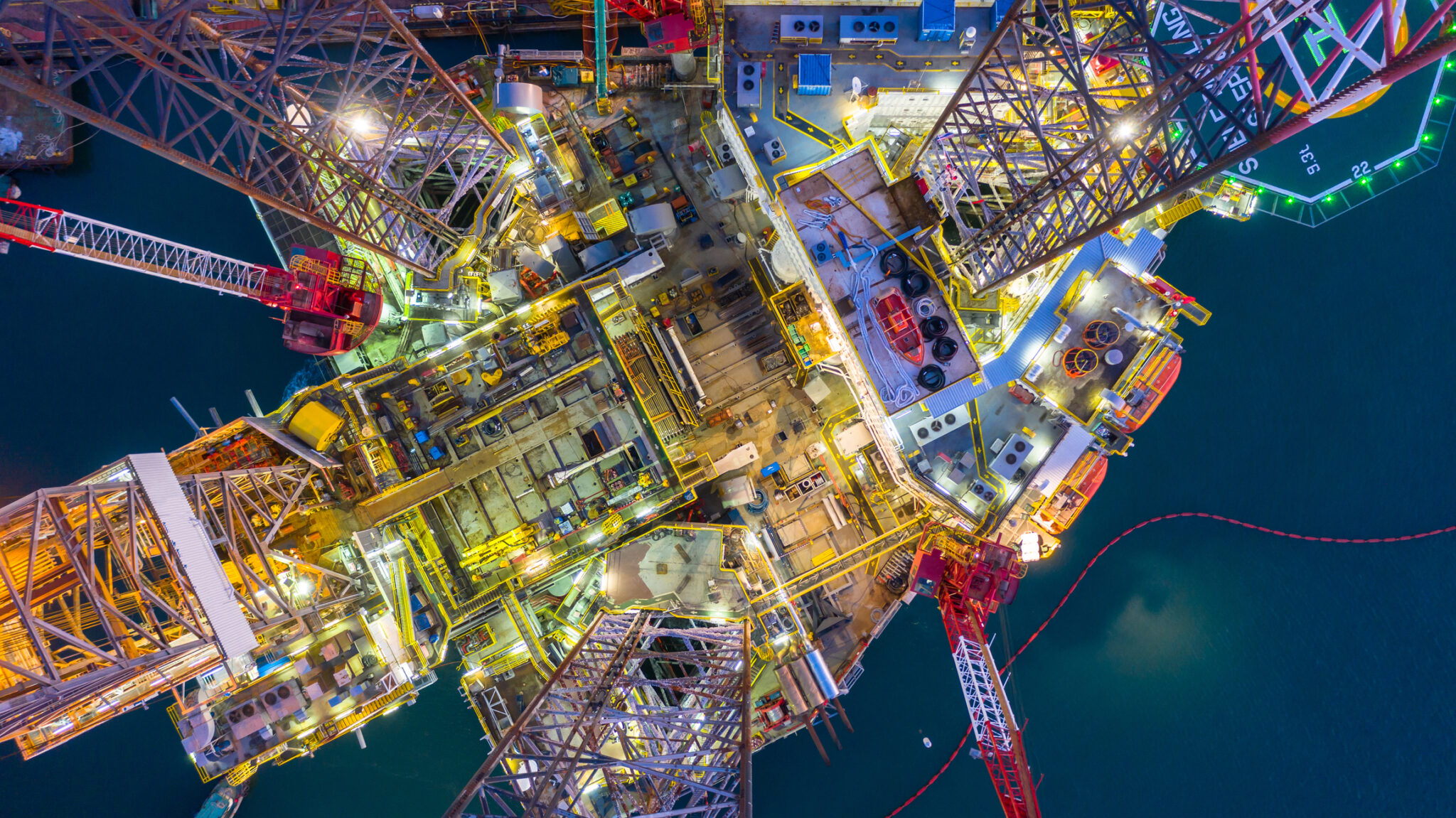 Aerial view offshore jack up rig  at night, Offshore oil rig drilling platform.