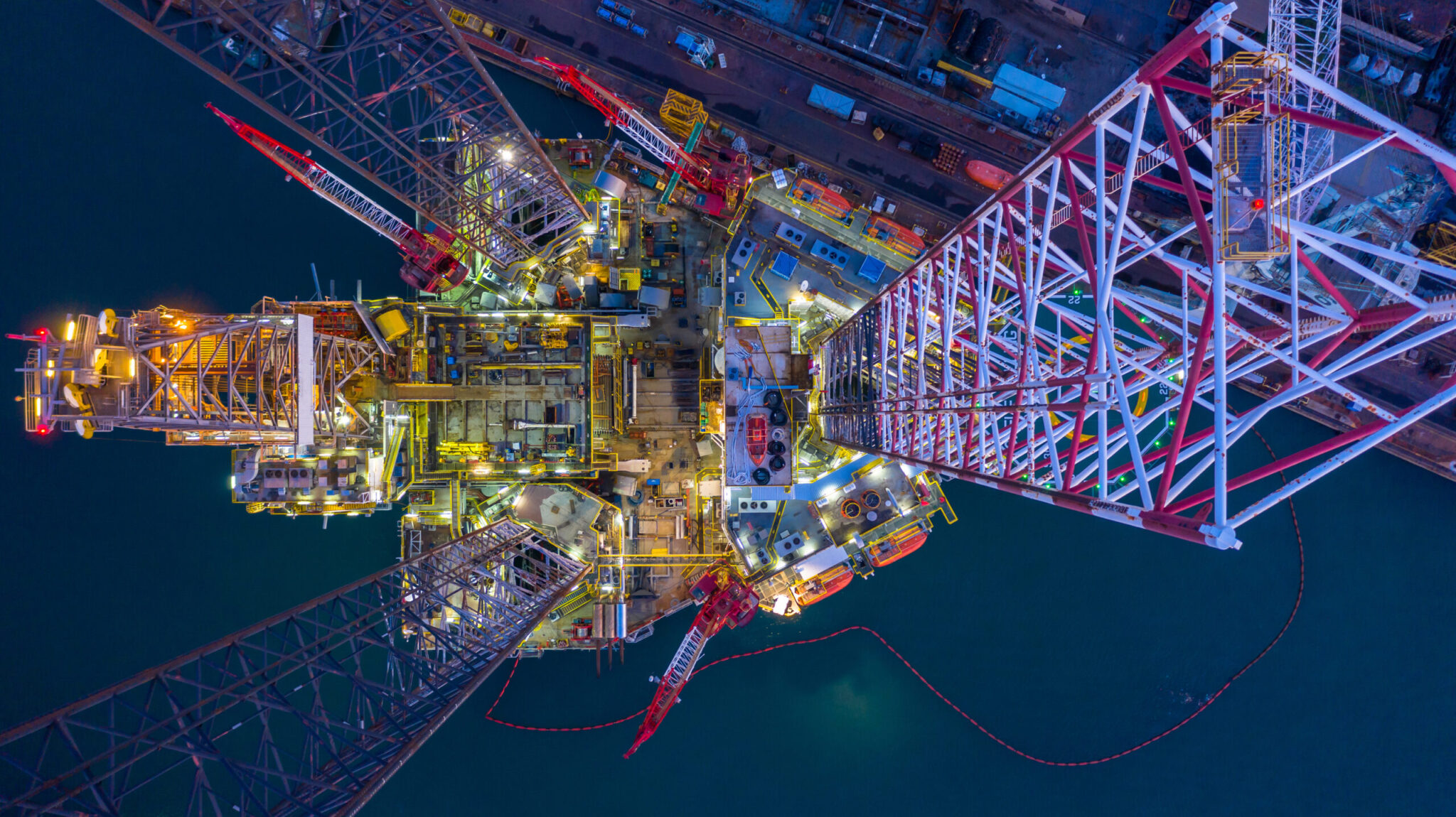 Aerial view offshore jack up rig  at night, Offshore oil rig drilling platform.